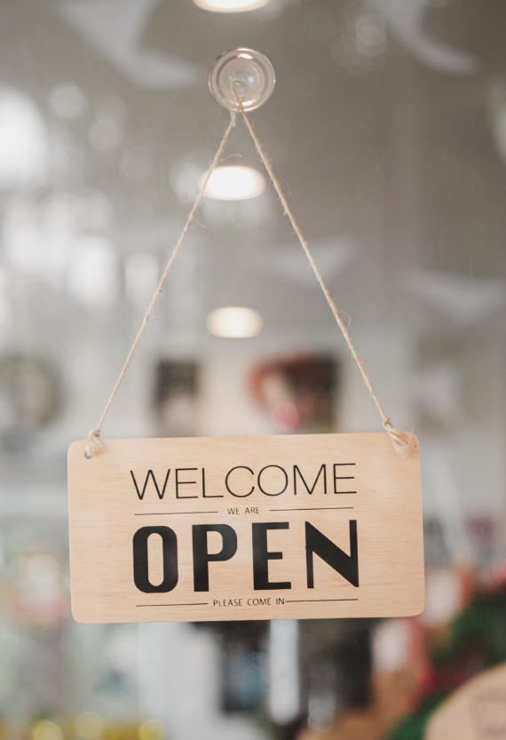 Open sign on glass door of a storefront